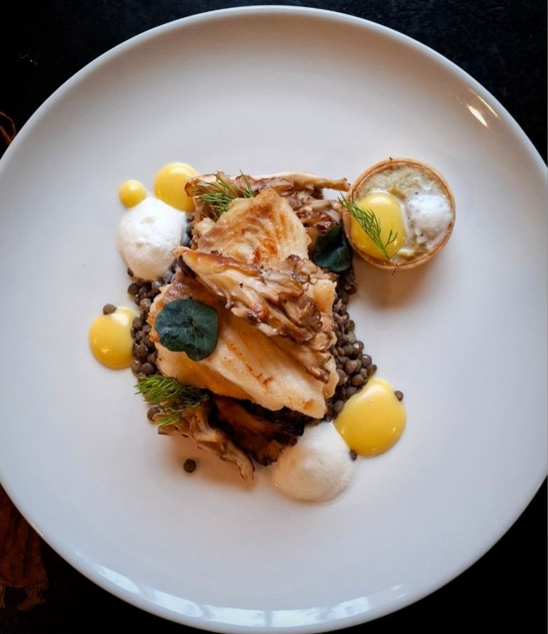 Artur’s plated fish dish with lentils and garnishes